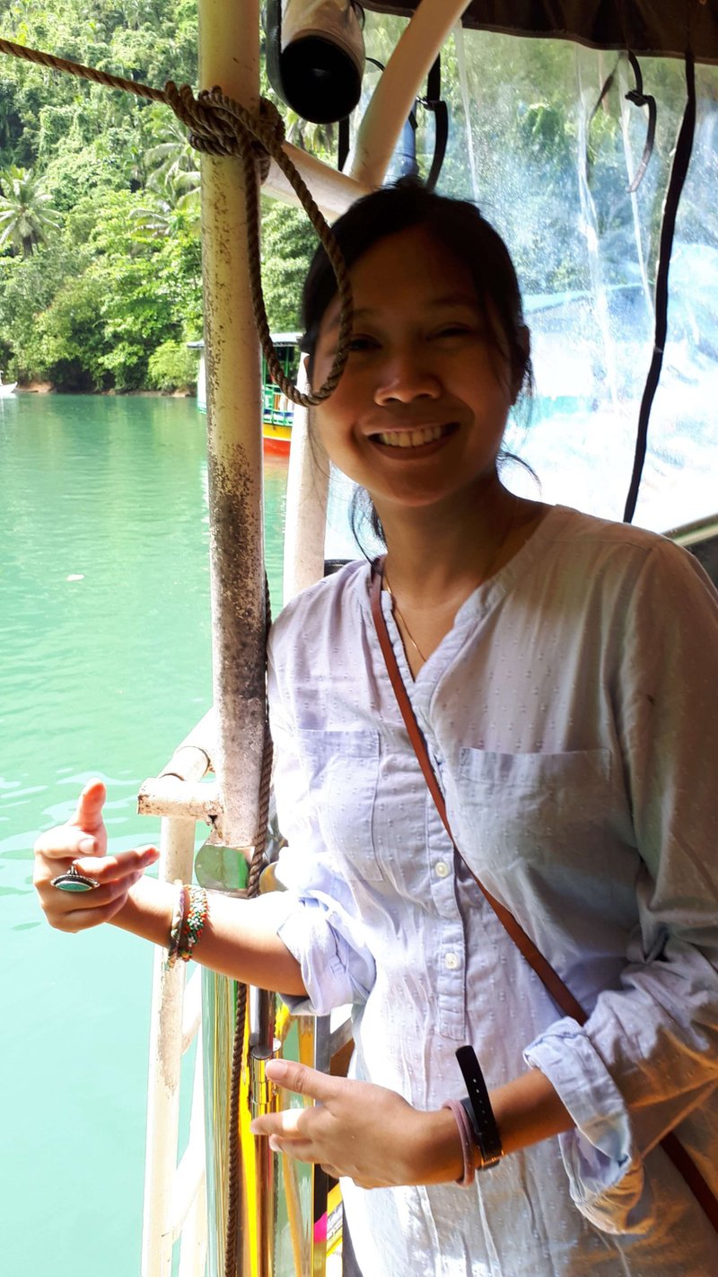 A young woman, with Loboc River as her background