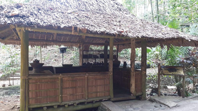 an open nipa hut furnished with kitchen utensils